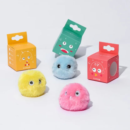 Three colorful plush toys with expressive faces on a white background, each in front of their respective packaging boxes.